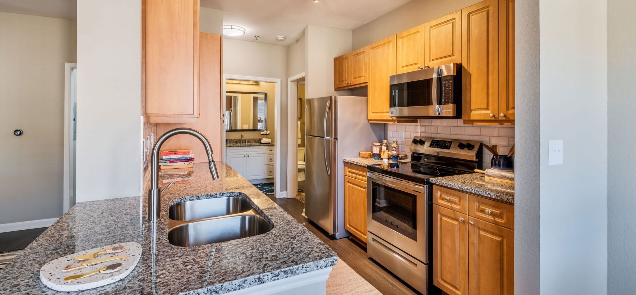 Hawthorne Davis Park apartment kitchen with wood floor and stainless steel appliances